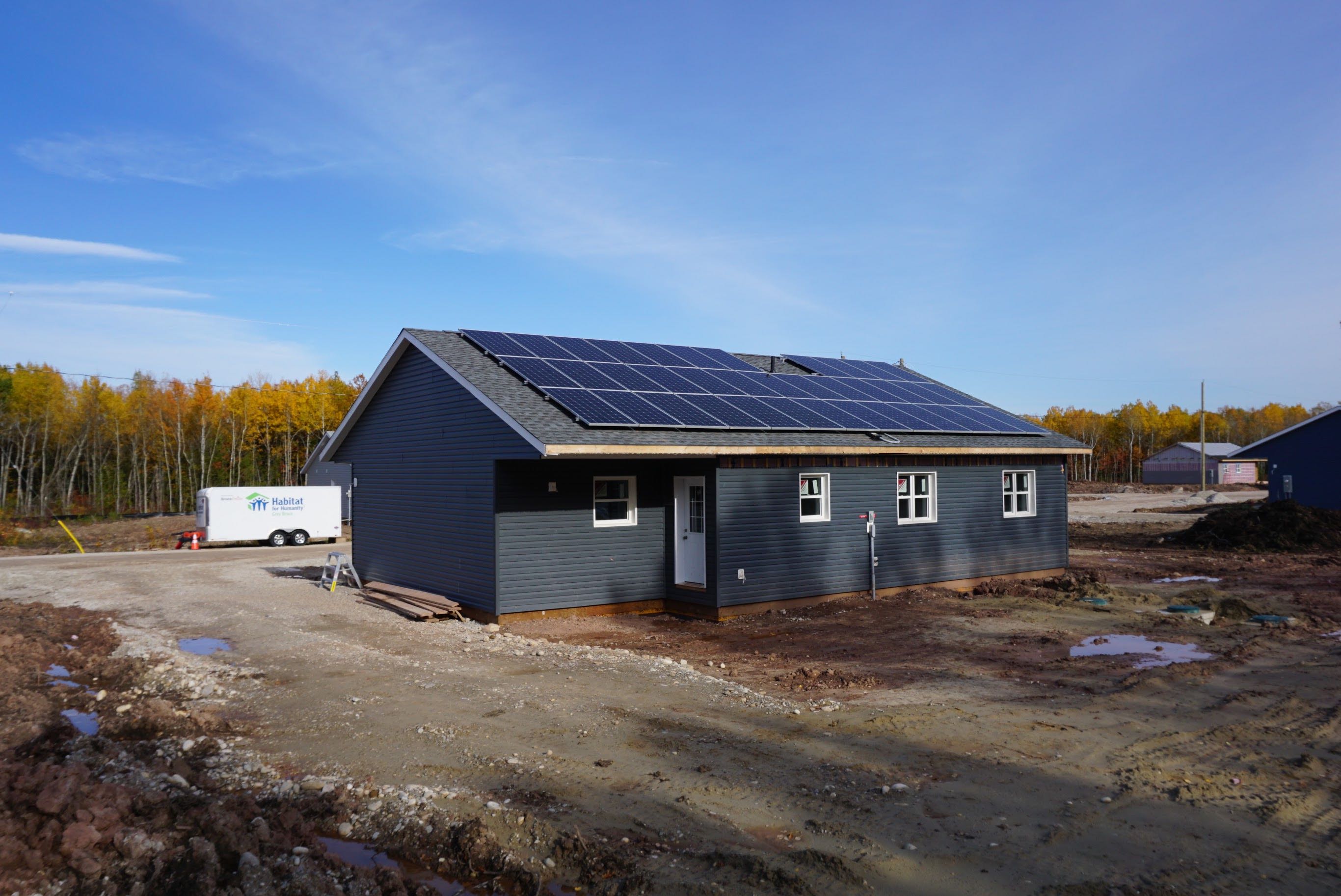 Photo of a newly constructed home with solar panels on the roof.