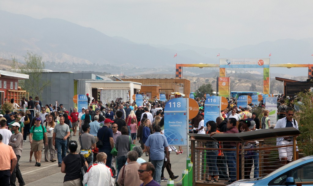 Photo of crowds of visitors within the Solar Decathlon village.
