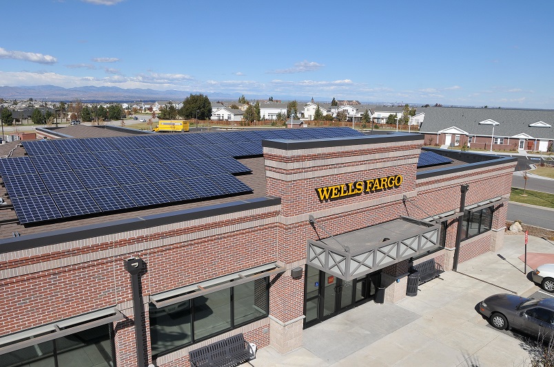 Photo of a Wells Fargo building with solar panels on its roof.