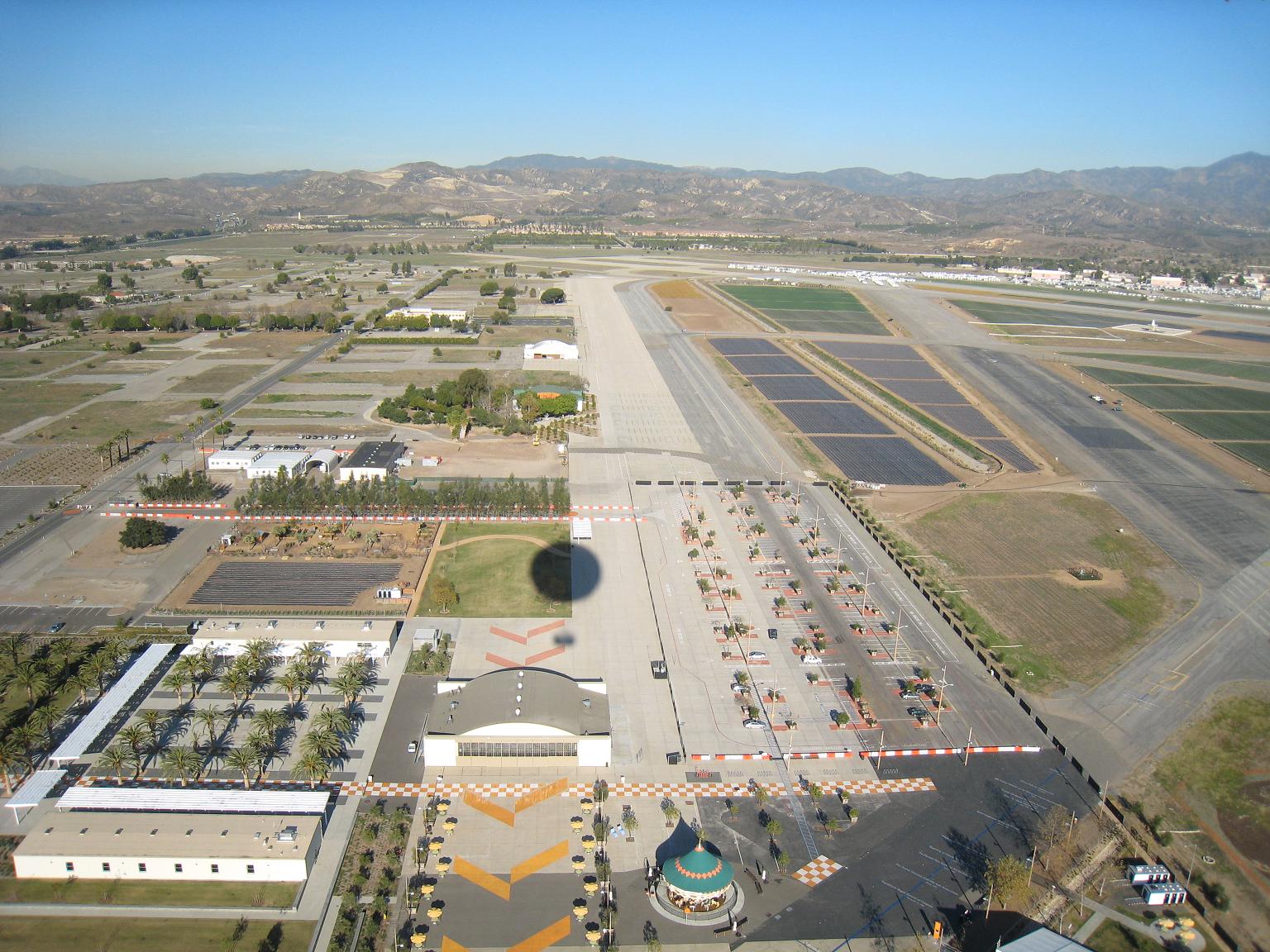 Photo of an air strip with mountains in the background.