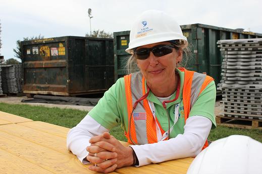 Photo of a woman wearing safety glasses, hard hat, and vest.