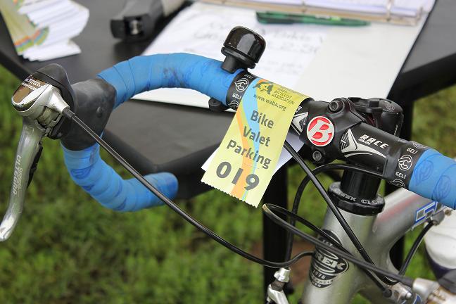 of a bike’s handlebar tagged with a valet number.