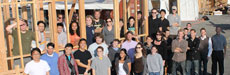Photo of the Southern California Institute of Architecture and California Institute of Technology Solar Decathlon team members standing in within and in front of a framed structure.