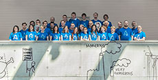Photo of the Czech Technical University Solar Decathlon  2013 team standing on a balcony marked with graffiti.