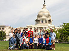Photo of members of the Catholic University of America,  George Washington University, and American University Solar Decathlon 2013 team  in front of the U.S. Capitol.