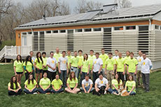 Photo of members of the Missouri University of Science  and Technology Solar Decathlon 2013 team standing in front of a solar-powered  house. 