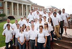 Photo of members of the University of North Carolina at  Charlotte Solar Decathlon 2013 team standing in front of Grigg Hall on campus.