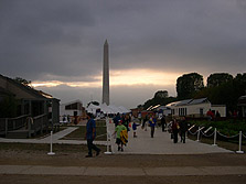 Photo of the solar village at the Solar Decathlon at dusk with the Washington Monument in the background.