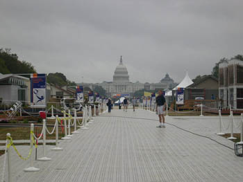 Photo of a rainy day at the Solar Decathlon with the houses and U.S. Capitol in the background.