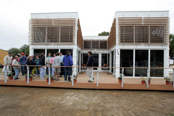 Photo of people lined up on the deck of a home.