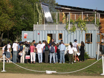 Photo of people gathered around the exterior of a mechanical room.