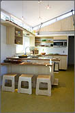 Photo of kitchen with small windows at ceiling height.