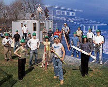 Photo of NYIT's team posing in front of its 2005 Solar Decathlon house superimposed on a partial computer-generated image of the house.