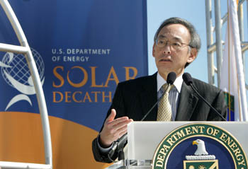 Photo of Steven Chu speaking from behind a podium with the U.S. Department of Energy seal. A U.S. Department of Energy Solar Decathlon banner is in the background.