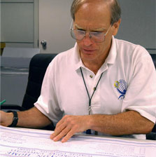 Photo of a man looking at drawings.