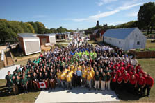 Photo of a large group of students standing together in a crowd at the end of Decathlete Way in the solar village. At the front center are Richard and Melissa King.