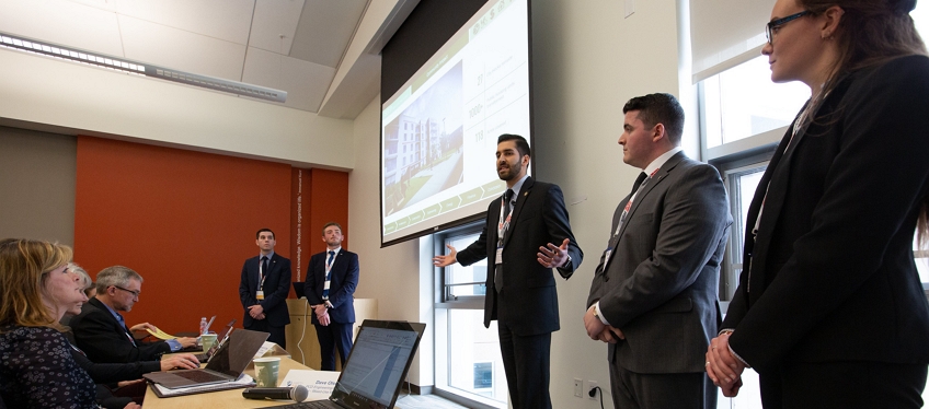 A group is presenting in front of Solar Decathlon judges panel.