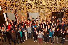 Photo of members of the Southern California Institute  of Architecture and California Institute of Technology Solar Decathlon 2013  team raising their arms in the air.