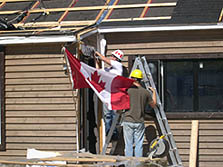 Photo of two team members from the Canadian Solar Decathlon team with the Canadian flag.