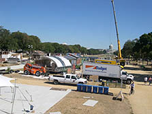 Photo of Solar Decathlon houses being assembled on the National Mall with the U.S. Capitol building in the background.