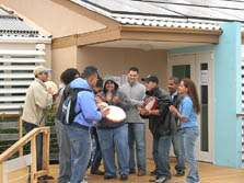 Photo of college students singing in front of their Solar Decathlon house.