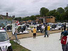 Photo of electric vehicles lining up for final lap to close the 2005 Solar Decathlon.