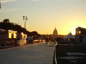 Photo of the Solar Decathlon solar village at sunrise with the US Capitol building in the background.