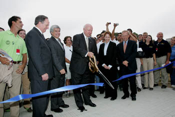 Photo of Secretary Bodman cutting ceremonial ribbon to open the 2005 Solar Decathlon.