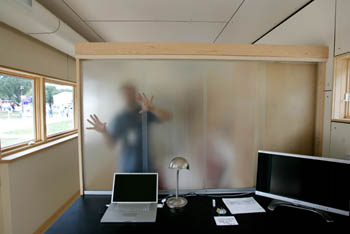 Photo of a person behind a translucent sliding room divider.