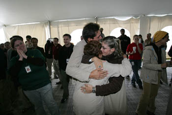 Photo of students hugging and smiling.