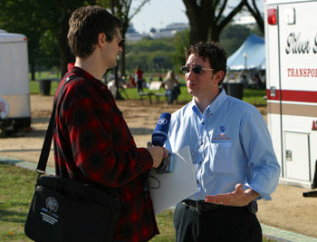 Photo of man with microphone interviewing man with Decathlon shirt.