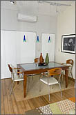 Photo of dining area with table and chairs.