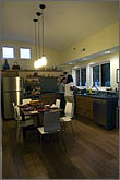 Photo of team Maryland's kitchen and dining area with students preparing a meal.