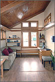 Photo of living room with wood-paneled ceiling.