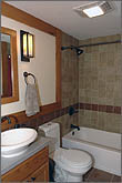 Photo of bathroom with wood accents and cabinets.