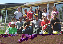 Photo of Canada's team standing and kneeling in front of its 2005 Solar Decathlon house.