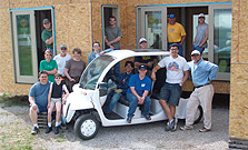 Photo of Crowder's team and a neighborhood electric vehicle in front of the team's 2005 Solar Decathlon house.
