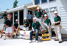 Photo of Missouri-Rolla's team wearing hardhats and posing in front of its 2005 Solar Decathlon house.