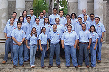 Photo of Puerto Rico's 2005 Solar Decathlon team standing in front of an archway with palm trees in the background.