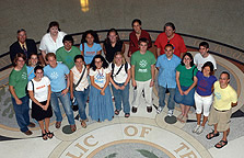 Photo of UT Austin's 2005 Solar Decathlon team looking up from the Texas Capitol's Rotunda.