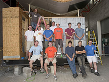 Photo of Virginia Tech's 2005 Solar Decathlon team in front of their raised, under-construction house.