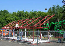 Photo of the Madrid team constructing the frame of their Solar Decathlon house.