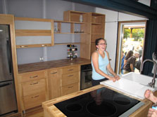 Photo of the kitchen, with light wood countertops and cabinets.