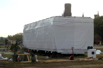 Photo of a solar home module wrapped tightly in plastic.