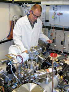 Photo of a scientist working with instruments and machinery.