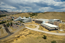 Photo with a view of the Science and Technology Facility, or S&TF, and the Solar Energy Research Facility, or SERF on campus. Both buildings are tucked against the foothills of Colorado.