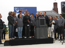 Photo of a group of young people on a small stage with a podium.