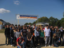 Photo of a group of middle school students posing underneath a Solar Decathlon banner.