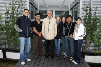 Photo of Senator Bingaman with a group of Rice University students on the deck of their team house.
