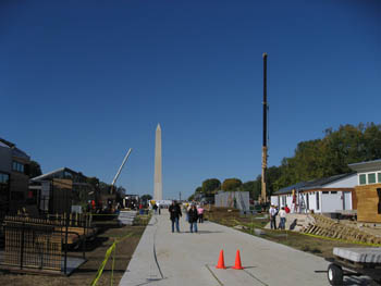 Photo of Decathlete Way with the Washington Monument in the background and cranes along the sides.